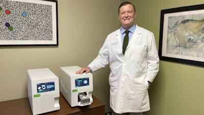 Dr. Jeremy Woods, Valley Children's Precision Medicine Director, with machine that tests for changes in the MT-RNR1 gene.