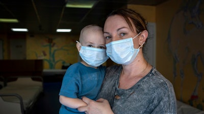 Oksana Halak poses for a portrait with her son Dmytro, 2, at the National Cancer Institute in Kyiv, Ukraine, Wednesday, July 10, 2024. Dmytro is one of 31 young patients battling cancer who were relocated to the hospital from Okhmatdyt Children’s Hospital after it was struck by a Russian missile this week.