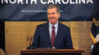 North Carolina Gov. Roy Cooper touts Medicaid expansion reaching 500,000 enrollees during a news conference at the North Carolina Executive Mansion in Raleigh, N.C., on Friday, July 12, 2024. It took about seven months to reach 500,000 enrollees, which Cooper said exceeded his office's expectations.