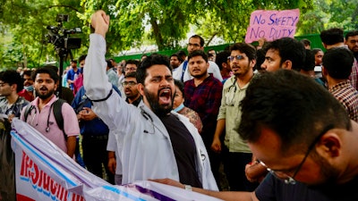 Doctors and paramedics protesting against the rape and killing of a trainee doctor at a government hospital in Kolkata gather in front of the Indian health minister's office, in New Delhi, India, Monday, Aug. 19, 2024.