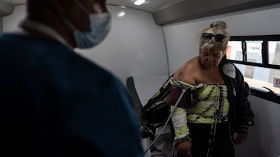 Norma Terrazas, right, gets her blood pressure checked by medical assistant Henry Gil Maturell in Wesley Health Centers' mobile clinic in the Skid Row area of Los Angeles, Tuesday, Aug. 27, 2024.