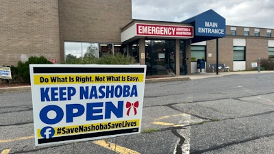 A sign pushing to keep the hospital open stands outside Nashoba Valley Medical Center in Ayer, Mass., Tuesday, Aug. 20, 2024.
