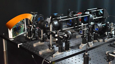 The experimental setup shows the optical components, including the DMD and beam scanners, for the two-photon microscope with the adaptive line-excitation scheme.