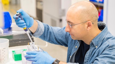 A lab technician prepares DNA samples for analysis at Complete Genomics in San Jose, Calif., Monday, July 22, 2024.