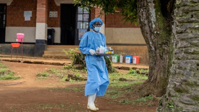 A health worker carries medication to be giving to a man suffering for mpox at the Kamituga General Hospital in South Kivu Congo, Wednesday, Sept. 4, 2024.