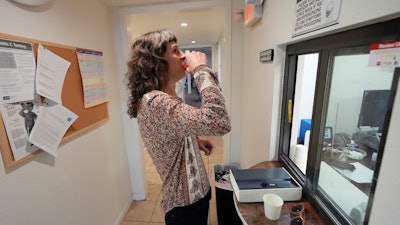 Methadone patient Irene Garnett, 44, of Phoenix, takes her treatment at a clinic in Scottsdale, Ariz., on Monday, Aug. 26, 2024.