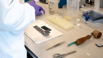 The materials used in Professor Zhugen Yang's new method of identifying biomarkers sit on a laboratory work surface at Cranfield University, UK.