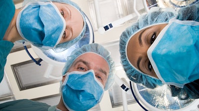 Surgeons looking down during surgery.
