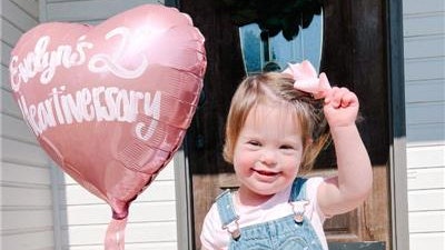 Three-year-old Evelyn Hamm holds a balloon celebrating her second 'heartiversary,' the date she had open-heart surgery to fix a congenital heart defect.