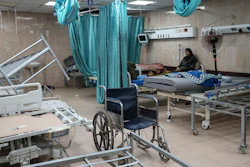 A woman sits on a bed in a room of the Al-Aqsa Martyrs hospital in Deir al Balah, Gaza Strip, Aug. 25, 2024.