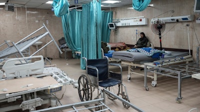 A woman sits on a bed in a room of the Al-Aqsa Martyrs hospital in Deir al Balah, Gaza Strip, Aug. 25, 2024.