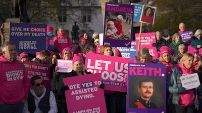 Pro legal assisted dying supporters demonstrate in front of Parliament in London, Friday, Nov. 29, 2024 as British lawmakers started a historic debate on a proposed to help terminally ill adults end their lives in England and Wales.
