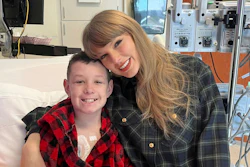 In this image provided by Cassie Thomas, Beckett Thomas, 13, who is a patient at Children's Mercy Hospital in Kansas City, Mo., poses with Taylor Swift, Thursday, Dec. 12, 2024.