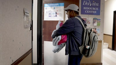 Alex Berrios walks into his dialysis session in Louisville, Ky., on Oct. 4, 2024.
