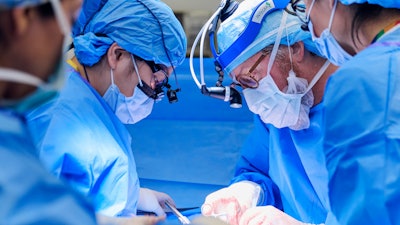 Kryscilla J. Yang, MD, clinical instructor for the NYU Langone Transplant Institute, from left, and Robert Montgomery, MD, H. Leon Pachter, MD, Professor of Surgery, chair of the NYU Grossman School of Medicine Department of Surgery, and director of the NYU Langone transplant Institute, prepare patient Towana Looney to receive a gene-edited pig kidney at NYU Langone Health in New York City on Nov. 25, 2024.