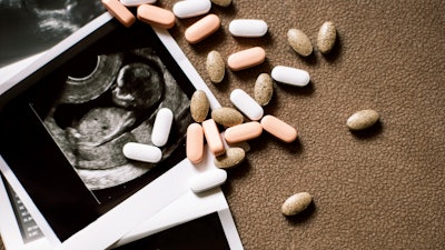 Prenatal supplements accompanied by ultrasound photos.