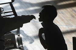 A medical worker takes a swab sample from a worker of the China Star Optoelectronics Technology (CSOT) company during a round of COVID-19 tests in Wuhan in central China's Hubei province, Aug. 5, 2021.