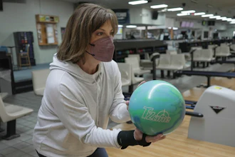 Susan Scarbro bowls while wearing a mask in Little River, S.C. on Jan. 3, 2025.