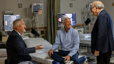 In this photo provided by Massachusetts General Hospital, patient Mike Garrity, center, speaks with Drs. Joe Garasic, left, and Randy Zusman in Boston, on Sept. 25, 2024.