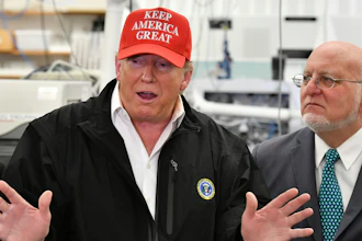 President Donald Trump speaks to members of the press as Director Robert Redfield, right, looks at the headquarters of the Centers for Disease Control and Prevention in Atlanta, March 6, 2020.