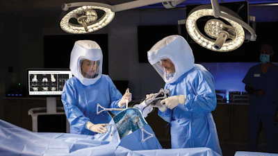 Two surgeons performing total knee arthroplasty in an OR utilizing the VELYS robotic assisted technology.