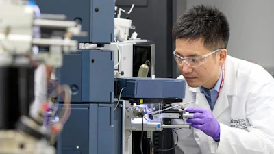 WashU Medicine researcher Kanta Horie, PhD, places a sample in a mass spectrometer that measures protein levels in blood plasma and other fluids. Horie co-led the development of a blood test for Alzheimer’s disease that diagnoses and stages the disease by using mass spectrometry to measure the level of a protein called MTBR-tau243.