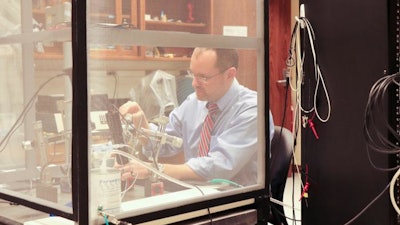 Jed Hartings works in his lab.