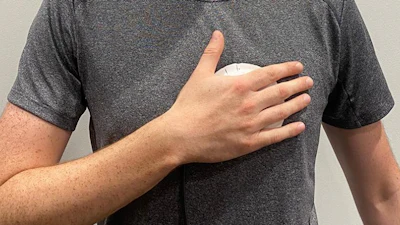 Person demonstrating use of a handheld device for heart disease screening.