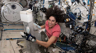 Flight Engineer Jasmin Moghbeli works onboard the ISS in March 2024 to retrieve bags containing heart cells for the Emory team's experiment.