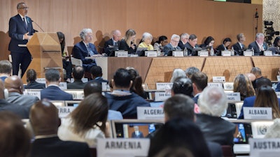 Director General of the World Health Organization (WHO) Tedros Adhanom Ghebreyesus, left, delivers his statement, during the opening of the 78th World Health Assembly at the European headquarters of the United Nations in Geneva, Switzerland, Monday, May 19, 2025.