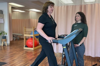 Terri Swain-Collins uses a treadmill in the care of physiotherapist Alison MacDonald on May 20, 2025, at Kingston Injury Management, a clinic in Kingston, Ontario, in Canada.