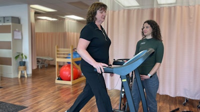 Terri Swain-Collins uses a treadmill in the care of physiotherapist Alison MacDonald on May 20, 2025, at Kingston Injury Management, a clinic in Kingston, Ontario, in Canada.