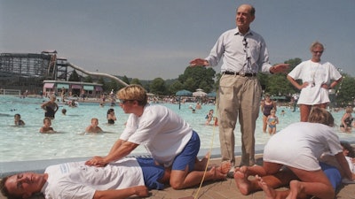 Dr. Henry J. Heimlich uses lifegaurds at Coney Island swimming pool in suburban Cincinnati on Friday, July 9, 1999, to demonstrate how the Heimlich maneuver can help save people from drowning.