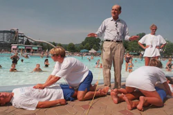Dr. Henry J. Heimlich uses lifegaurds at Coney Island swimming pool in suburban Cincinnati on Friday, July 9, 1999, to demonstrate how the Heimlich maneuver can help save people from drowning.