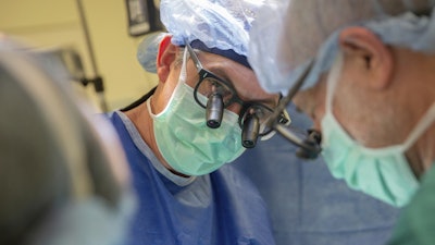 This photo provided by DukeHealth shows surgeon Joseph Turek during pediatric heart surgery in Durham, N.C., in 2021.