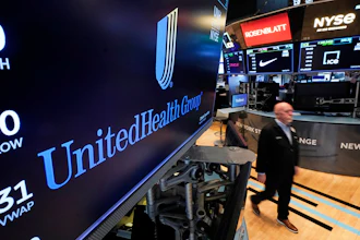 United Health Group logo displayed on NYSE trading floor screen