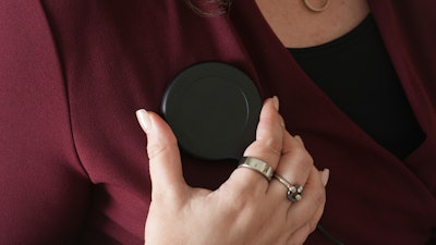 Brandy Ellis charges a pacemaker-like device that was installed in her chest as part of an experimental treatment for depression, on Thursday, July 24, 2025, in Delray Beach, Fla.