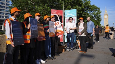 NHS resident doctors hold placards outside St Thomas' Hospital in London, as resident doctors in England, formerly referred to as junior doctors, begin a five-day strike after talks with the government collapsed over pay, Friday, July 25, 2025.