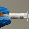 A pharmacist holds a Pfizer and BioNTech COVID-19 vaccine shot on Thursday, April 24, 2025, in Portland, Ore.