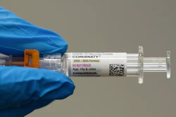 A pharmacist holds a Pfizer and BioNTech COVID-19 vaccine shot on Thursday, April 24, 2025, in Portland, Ore.