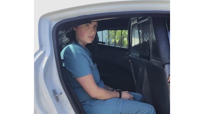 This photo provided by Flagler County Sheriff's Office in Florida shows Autumn Bardisa being taken into custody Tuesday, Aug. 5, in Palm Coast, Fla.