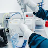 Scientist using micropipette in medical research laboratory