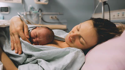 Woman With Newborn In Hospital Lower Res