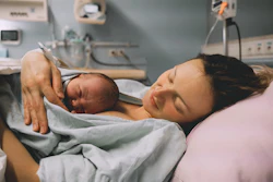 Woman With Newborn In Hospital Lower Res