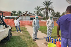 In this photo provided by Doctors Without Borders, men stand outside an Ebola treatment center in the remote Bulape Health Zone, Kasaï province, the Democratic Republic of Congo, Sept 7, 2025, that was set up following the outbreak of the Zaire strain of the Ebola virus.