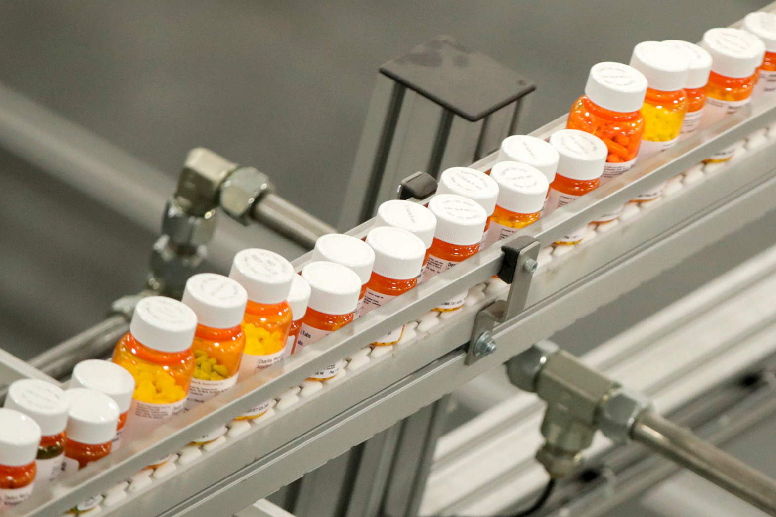 Bottles of medicine ride on a conveyor belt at a mail-in pharmacy warehouse in Florence, N.J., on July 10, 2018.