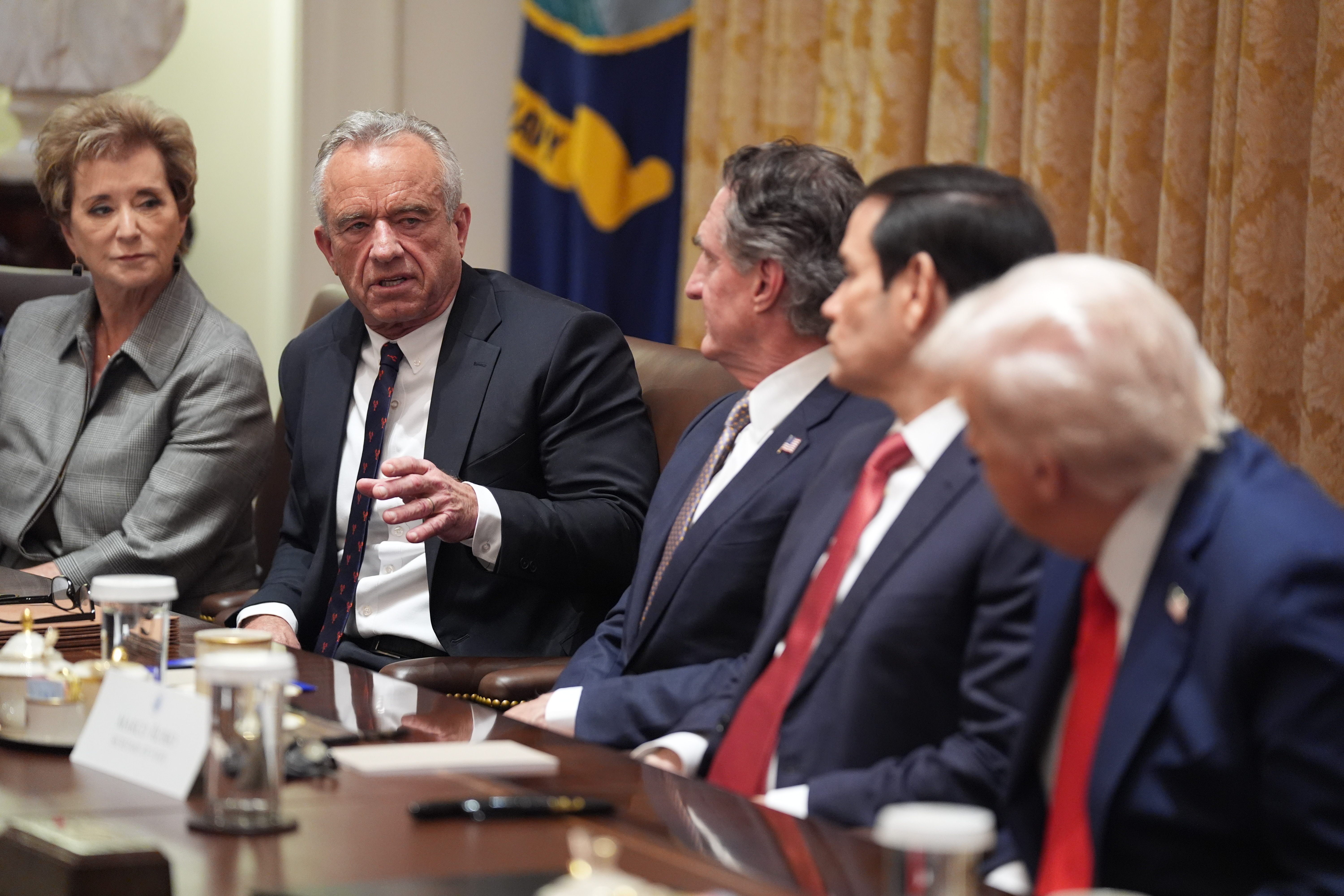 Human Services Secretary Robert F. Kennedy, Jr., speaks as President Donald Trump holds a cabinet meeting at the White House, Thursday, Oct. 9, 2025, in Washington. From left, Education Secretary Linda McMahon, Kennedy, Interior Secretary Doug Burgum, Secretary of State Marco Rubio and President Donald Trump, look on.