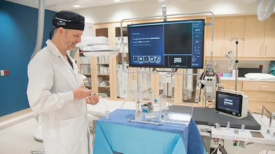 Dr. Derek Cool, Associate Scientist at London Health Sciences Centre Research Institute (LHSCRI) and Interventional Radiologist at London Health Sciences Centre (LHSC), demonstrating the equipment used to deliver radioactive beads to treat patients with kidney cancer.
