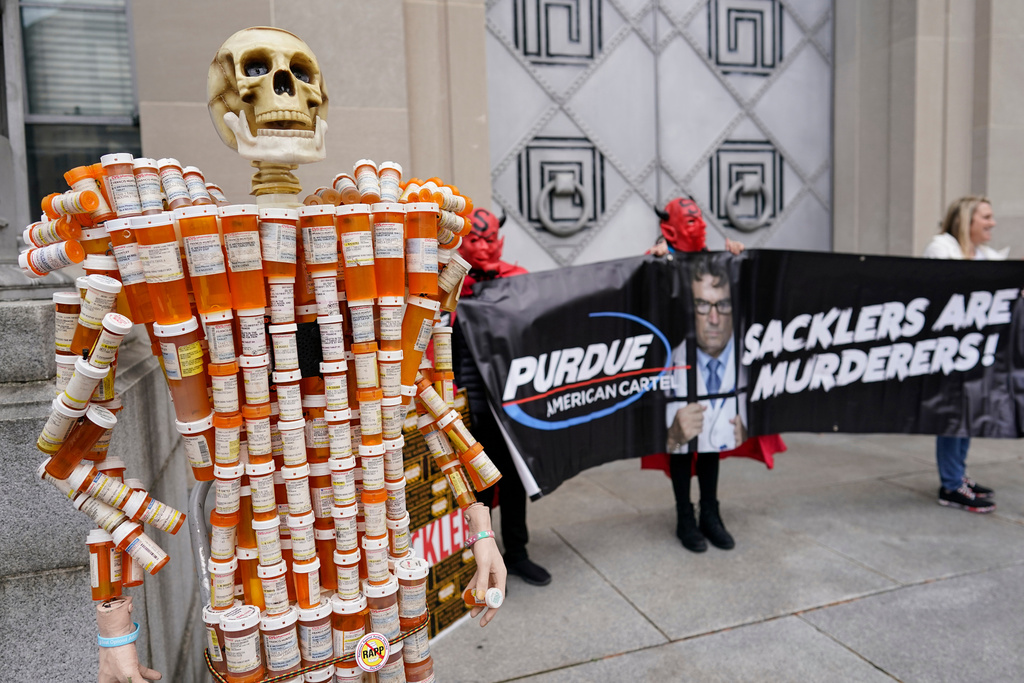 Skeleton made of prescription bottles protesting Purdue Pharma's role in opioid crisis