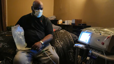 Ahmad Collins, a city government worker and former Penn State linebacker, prepares for his nightly dialysis at his home in Harrisburg, Pa., Thursday, Dec. 11, 2025.